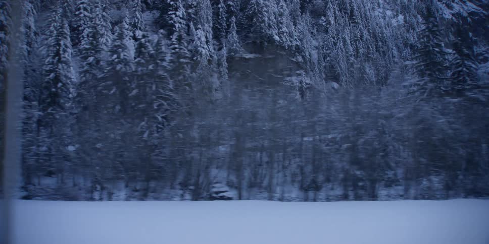 A lone building is located along a road in a snowcovered area