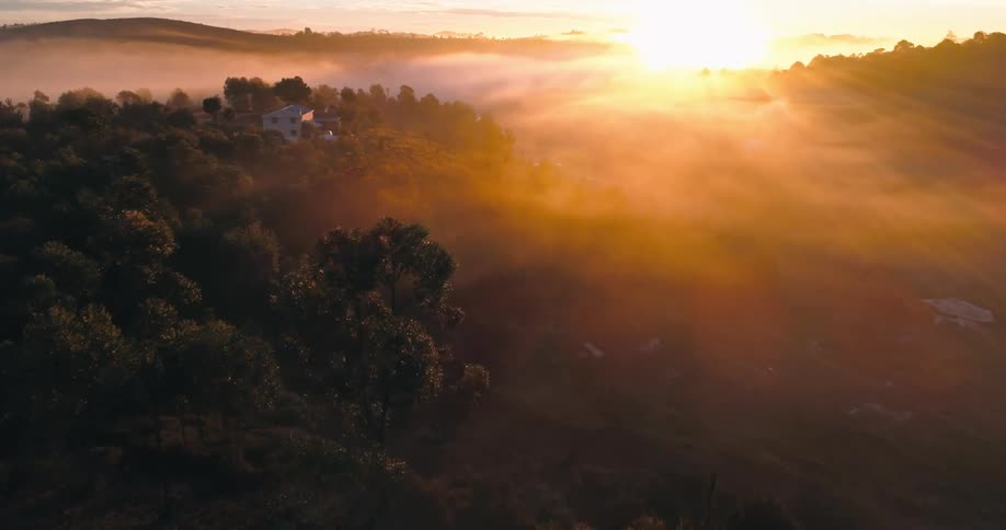 The sun sits low in the sky over a rural area