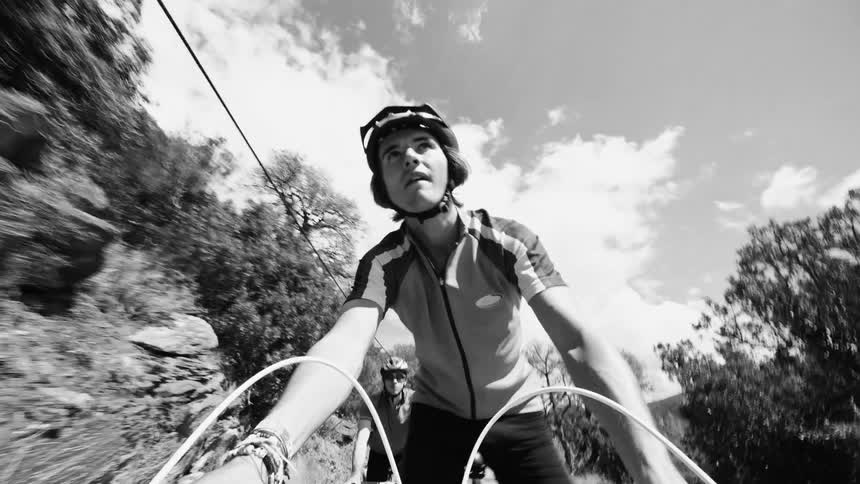 A man is racing his bike on the mountain