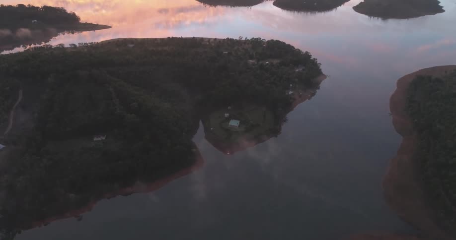Aerial landscape in the orange dawn of lakes with small islands around