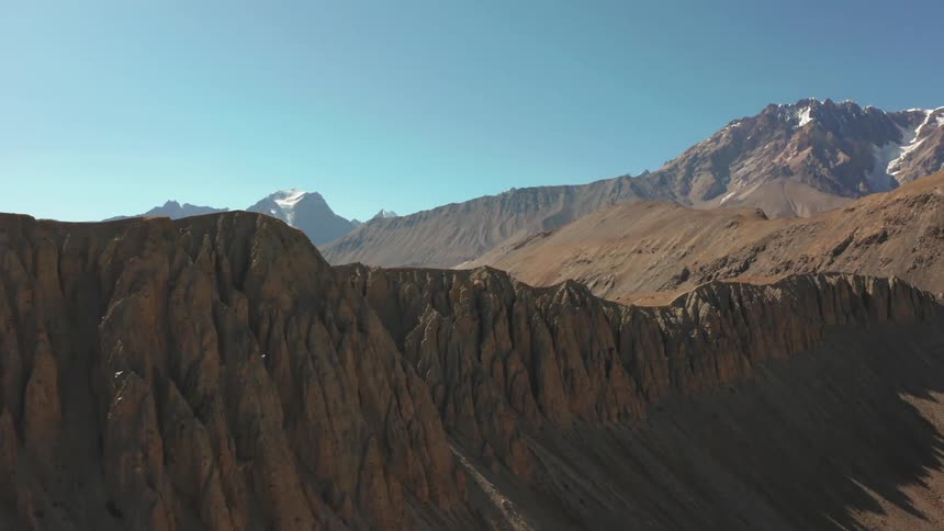 Aerial panorama of mountain ranges on a blue sky and winter day