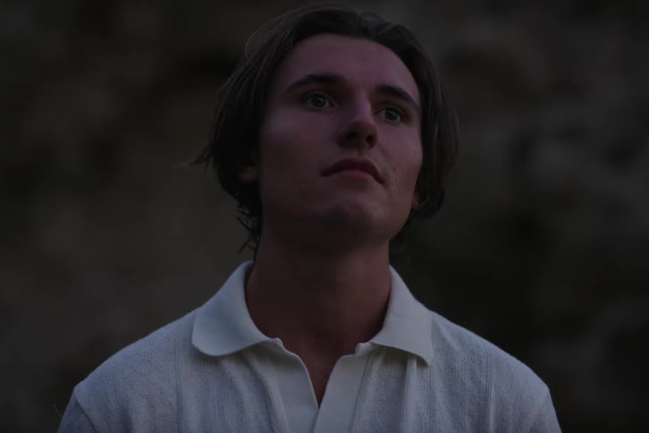 Portrait of a young man in a polo shirt in a natural environment looking straight ahead
