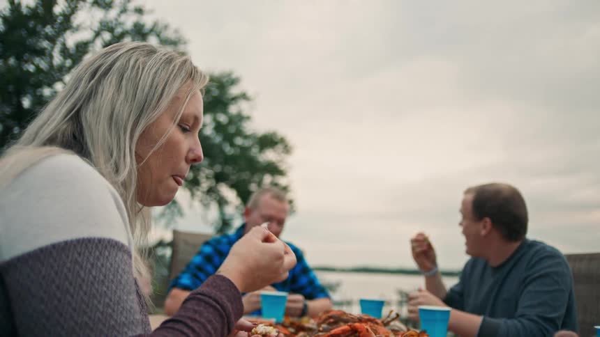 People eat seafood at an outdoor restaurant