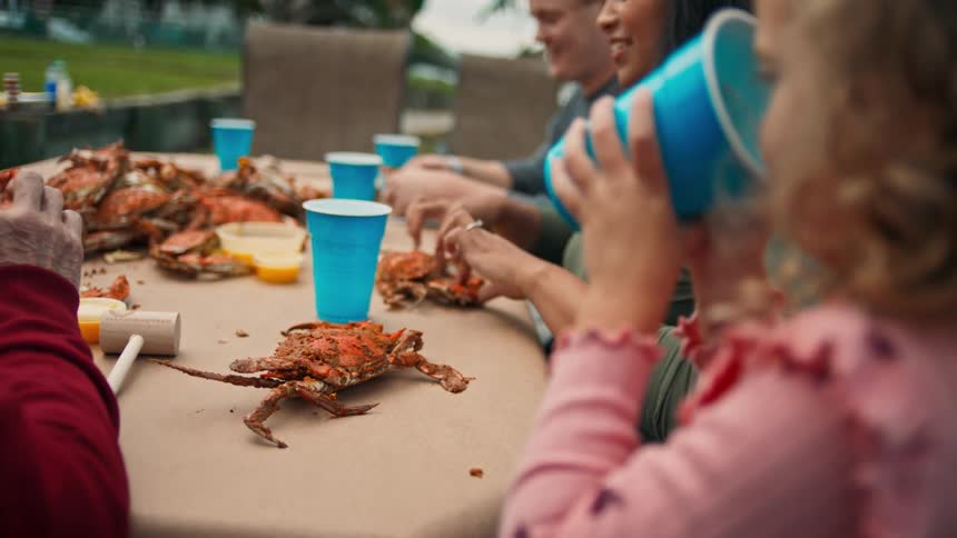 A group of people eating crabs outdoors