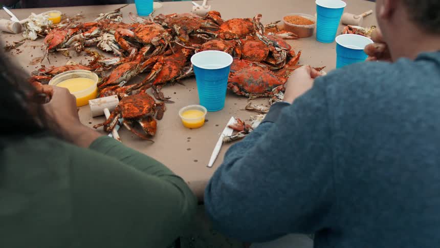 A group of people eat a fresh bunch of crabmeat together