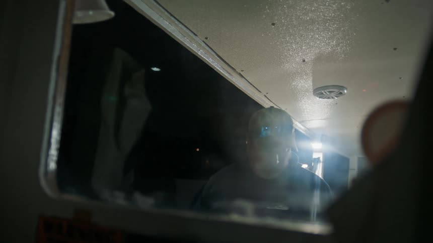A man on a boat looks disappointed as he turns and goes inside