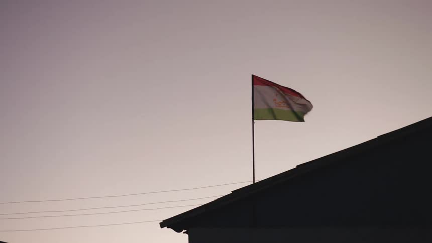 A flag flies on the roof of a building