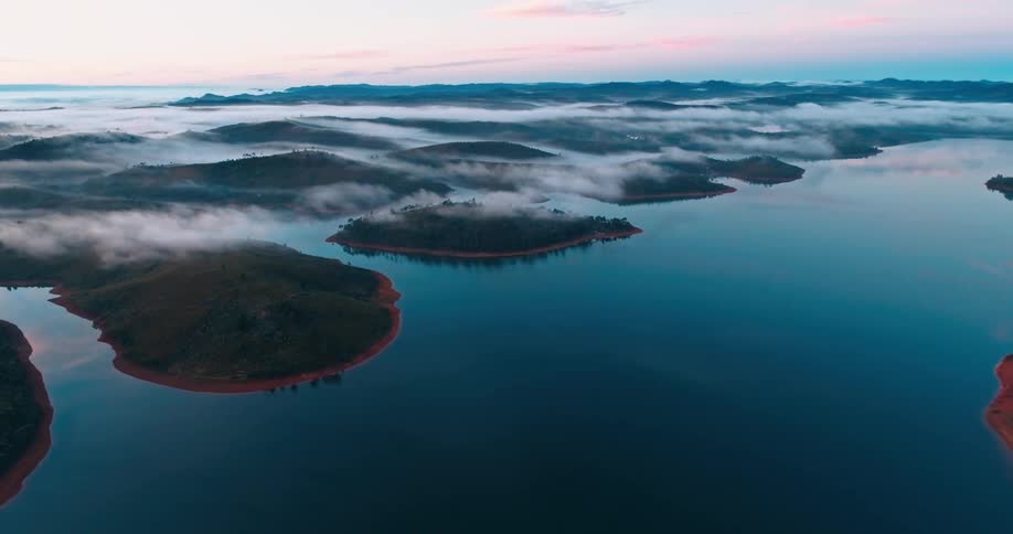 Aerial landscape of a peninsula with small islands on a morning with a purple sky