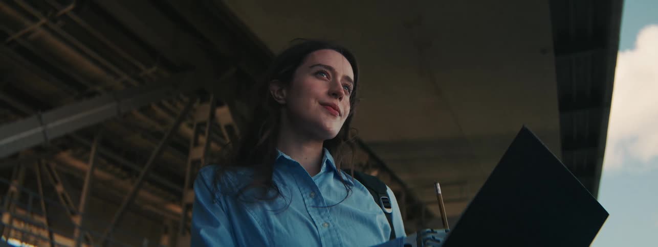 A woman is writing with a prosthetic arm