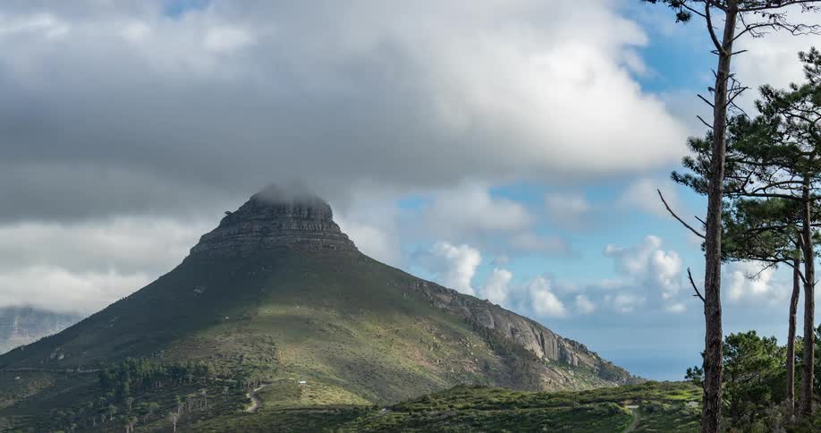 Clouds pass over mountain and busy highway