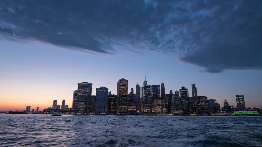 Time lapse of clouds moving over new york city at nightfall