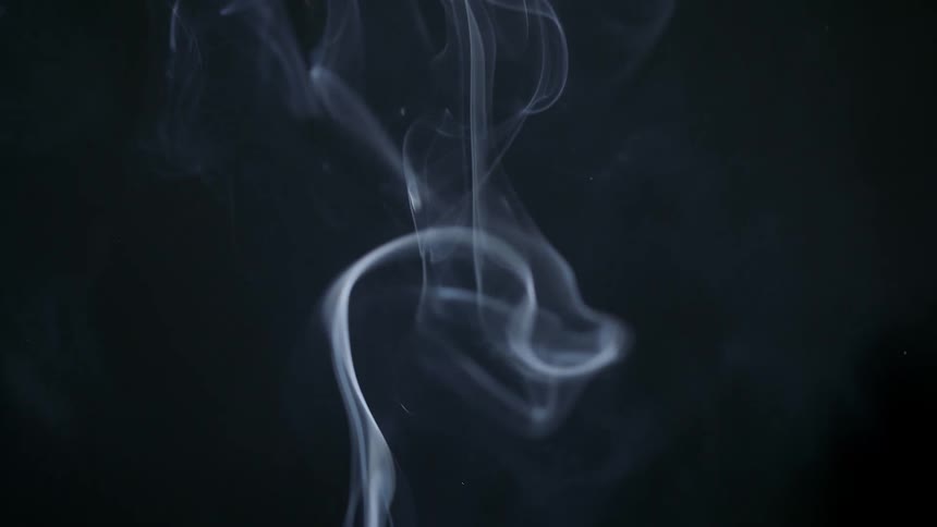 Extreme close up of smoke rising on a black background