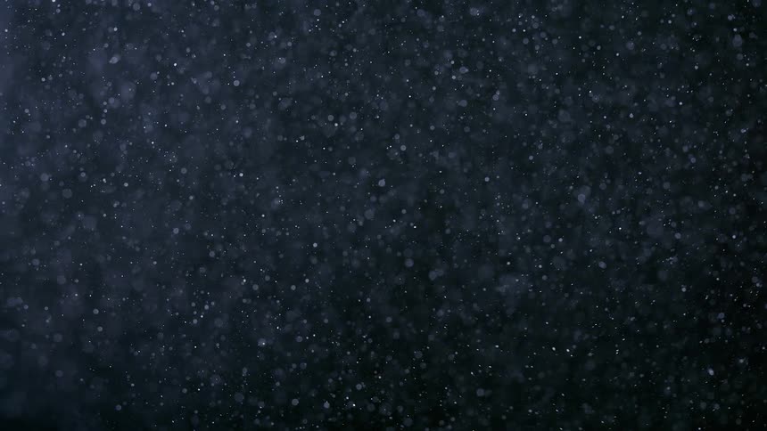 White powder in abstract movement and black background in slow motion