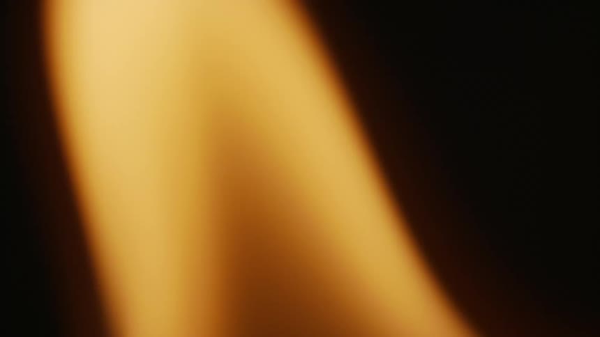 A blurry undulating flame