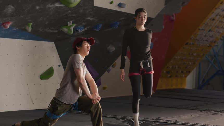Man and woman streching inside a gym