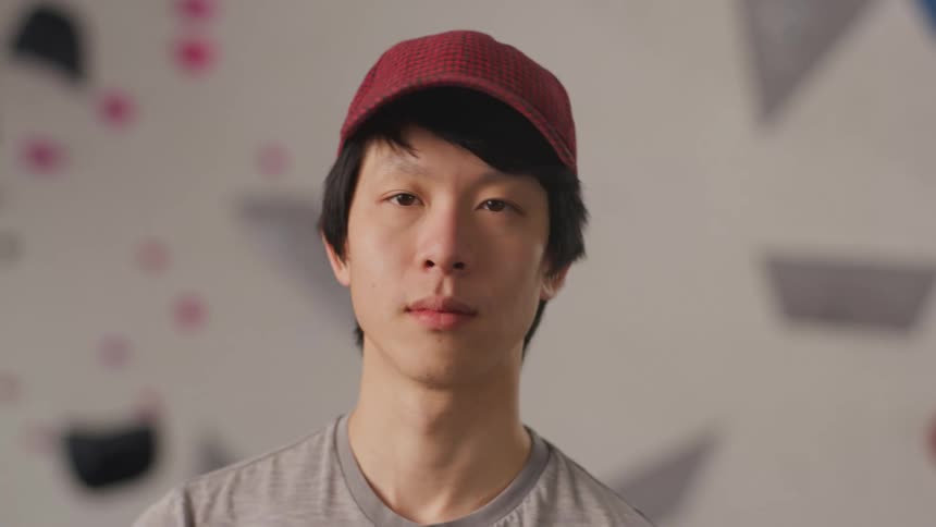 An asian man standing indoors