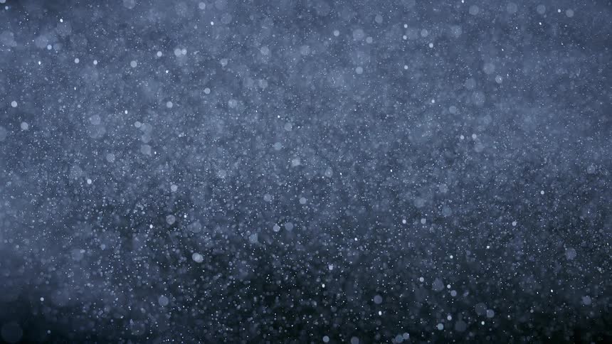 Silver glitter falls slowly into a pile below