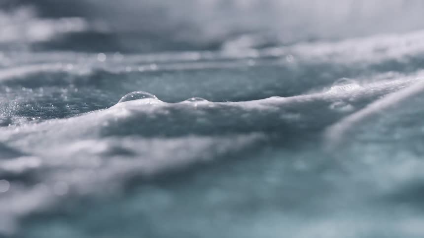 Close up of a foam layer over rippling water
