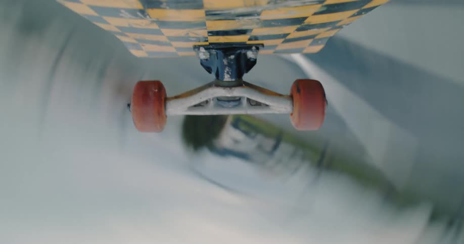 A skateboard flying and spinning through the air
