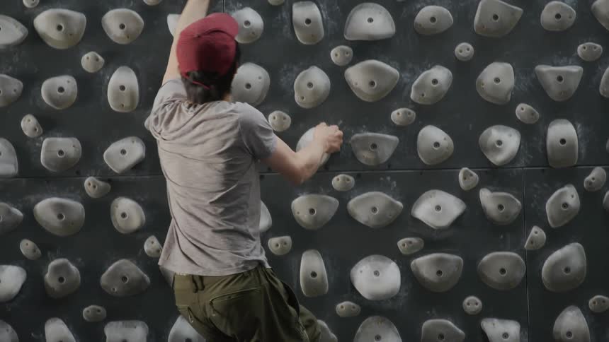 A person is climbing an indoor rock wall