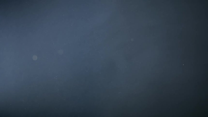 Stars forms spots of light shining through clouds at night