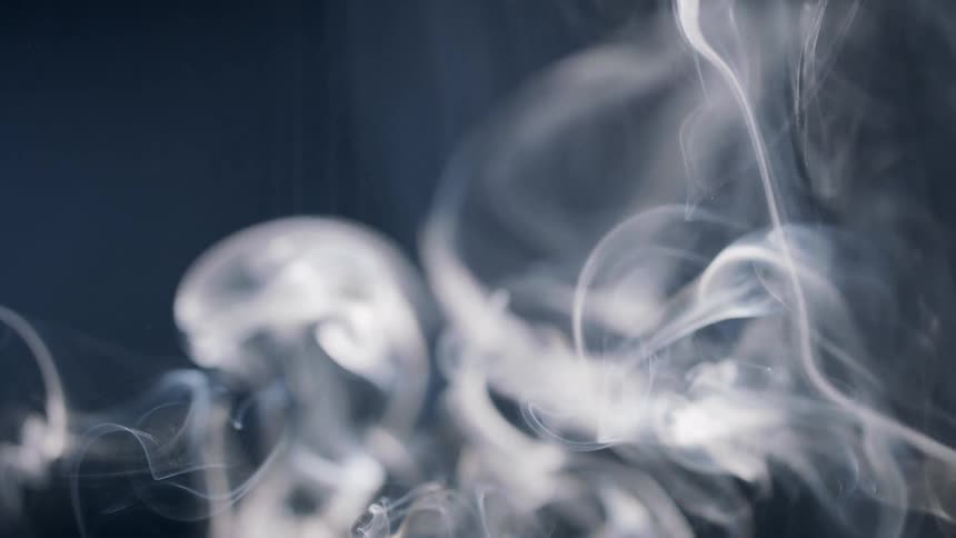 Extreme closeup of smoke rising in slow motion