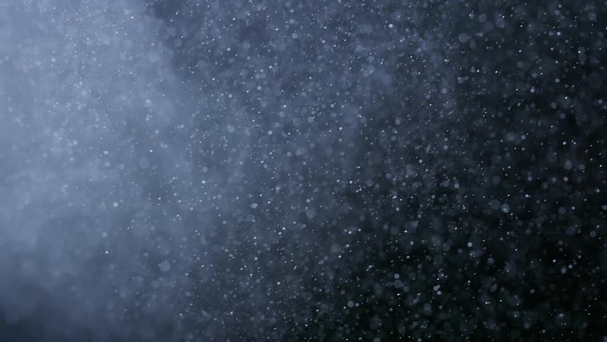 Extreme closeup on a bright white powder in an abstract movement and in slow motion on black background