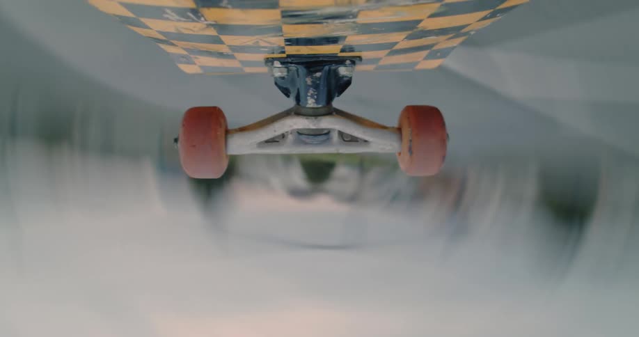 A skateboard flies and spins above the pavement