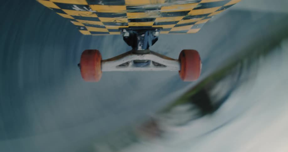 Point of view from underneath a skateboard spinning during a trick