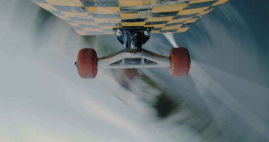 Point of view of the wheels of a skateboard spinning in a trick