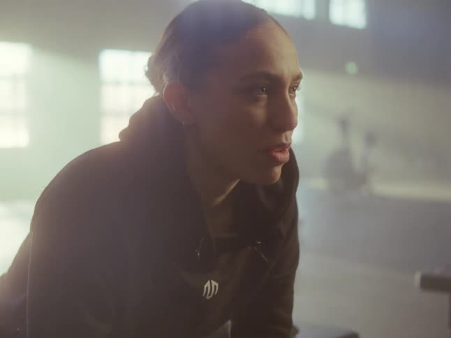 A woman sitting in a gym