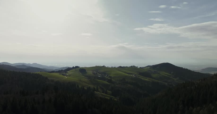 Aerial scenery of mountains and hills with forests in a morning