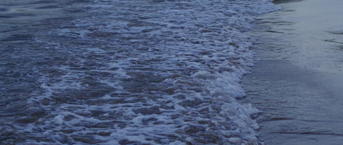 A view of waves rolling onto the coast