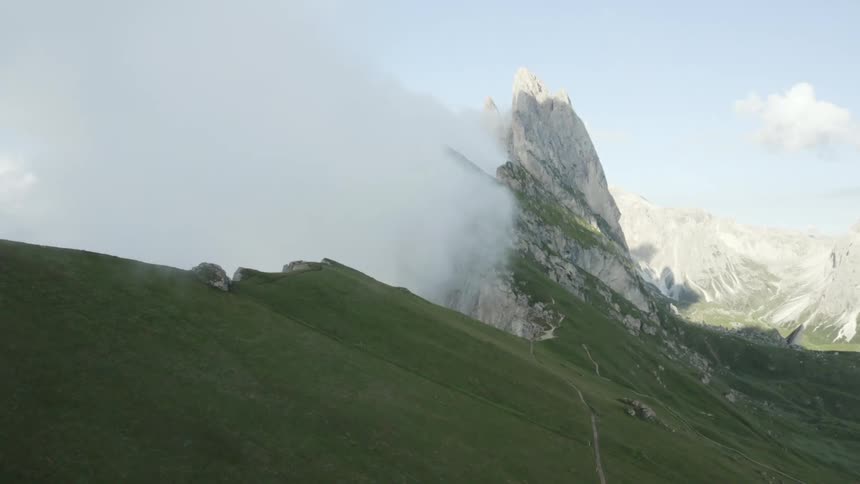 Mountain scenery with cliffs and greenish grass during the day