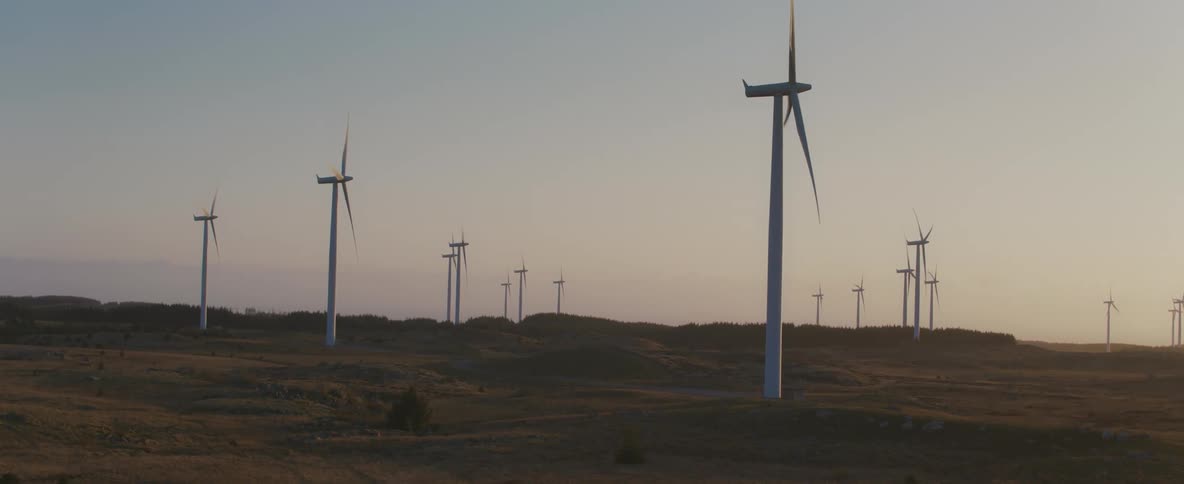 Turbines roating slowly on a wind farm at dawn
