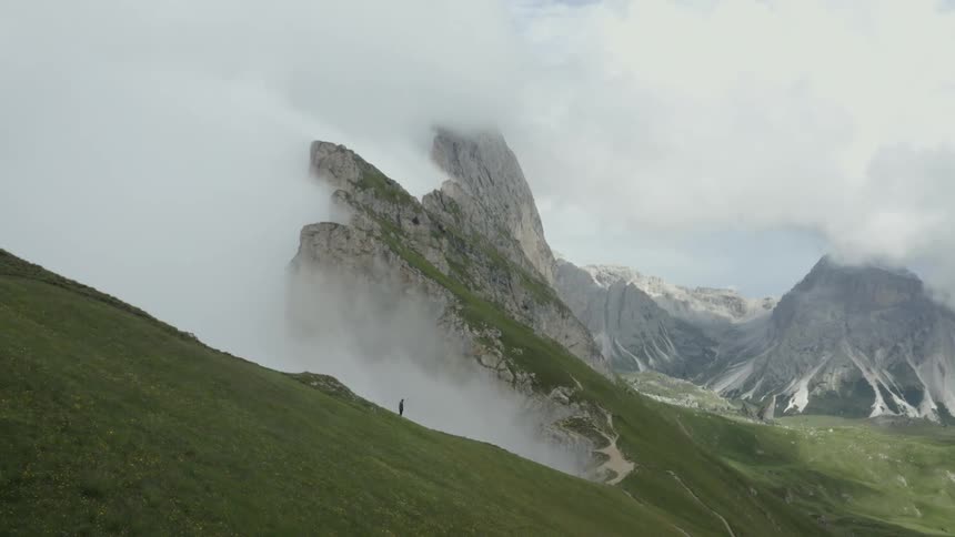 Natural scenery of mountains with grassy and greenish cliff with clouds around