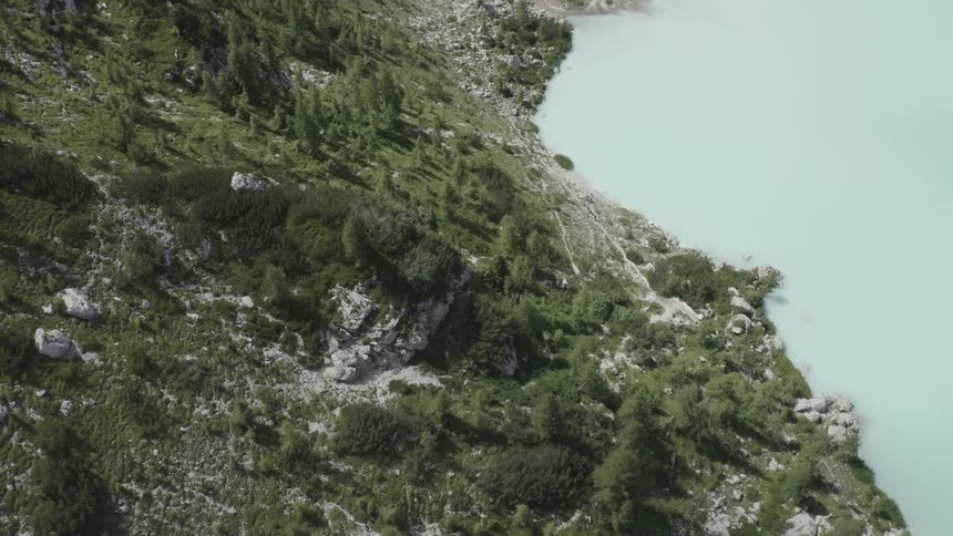 Aerial of a mountain next to large light blue lake