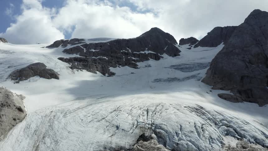 An aerial view of a mountain with snow on it