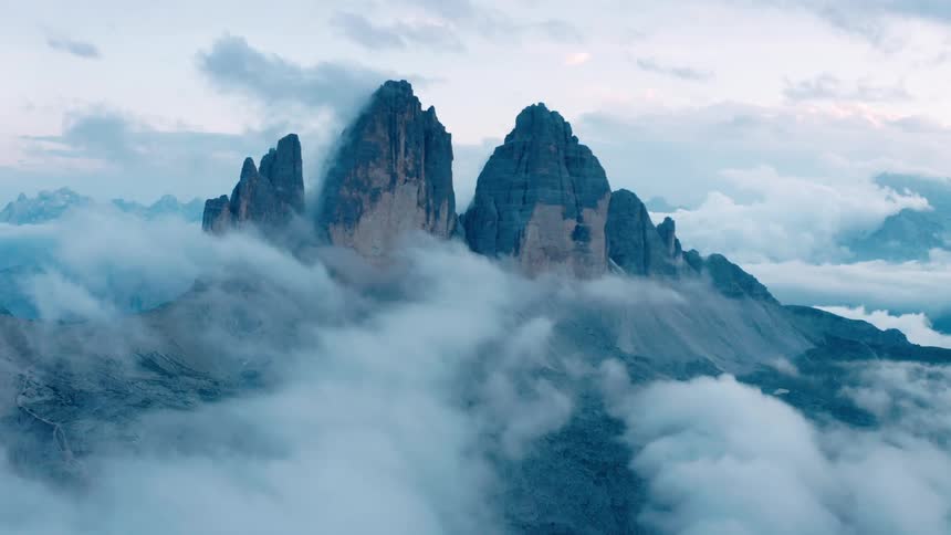 Clouds partially obscure giant mountains