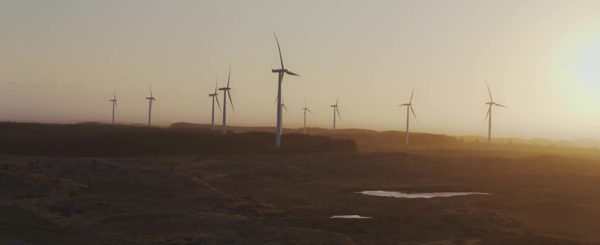 Natural scenery of fields with wind energy engine platforms in a morning