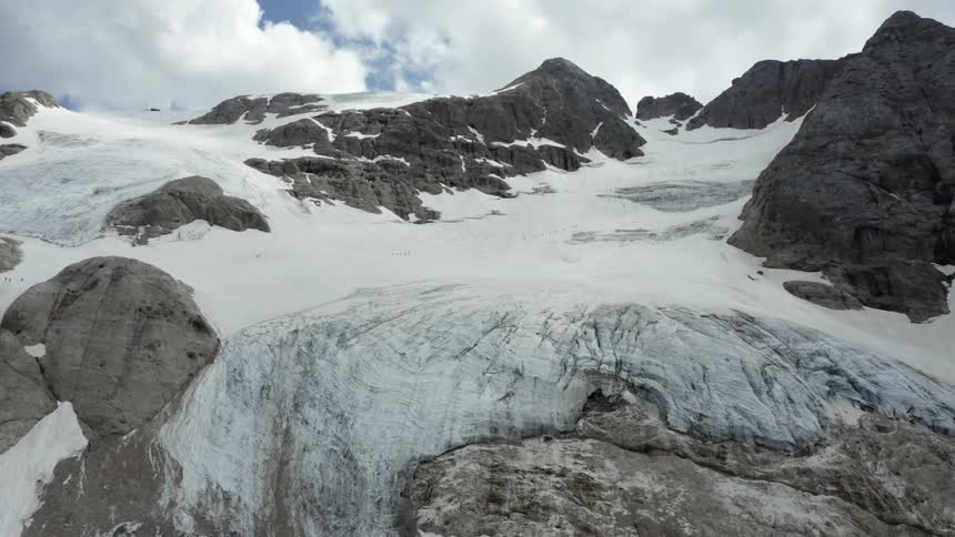 A glacier fills a mountain valley
