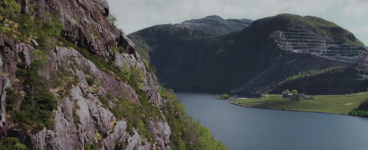 An aerial view of some mountains next to a lake
