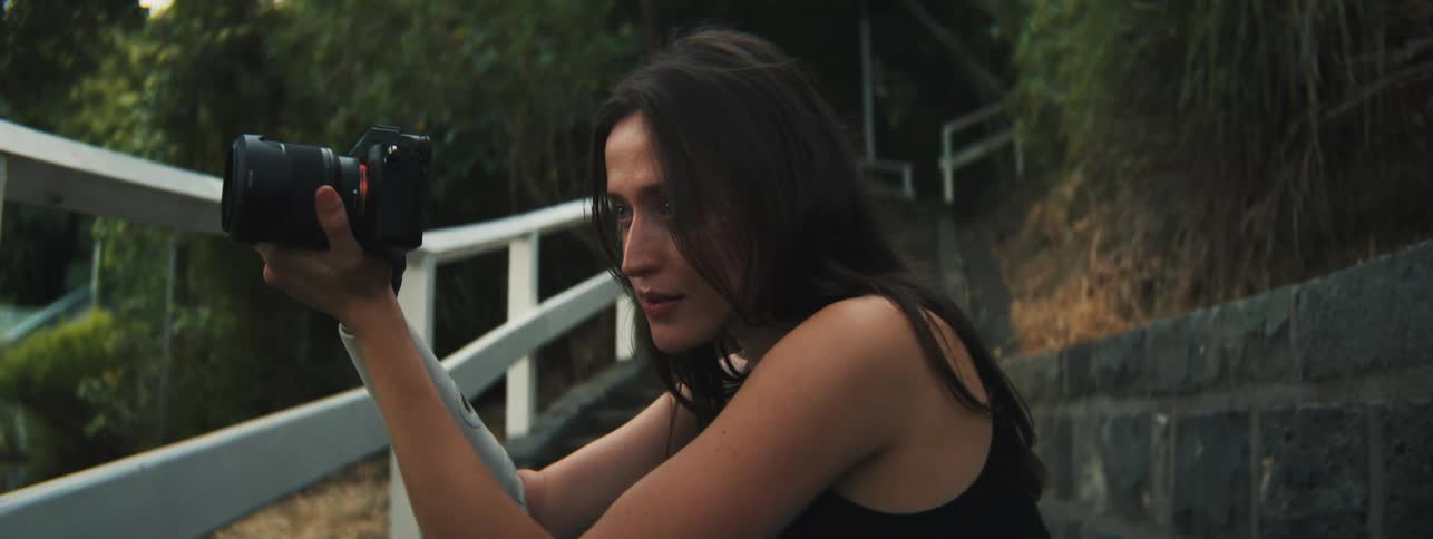 A woman is taking photographs outside