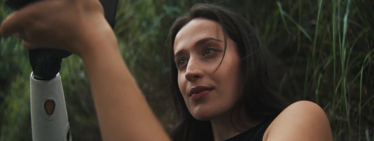 Portrait of a concentrated photographer using her professional camera outdoors