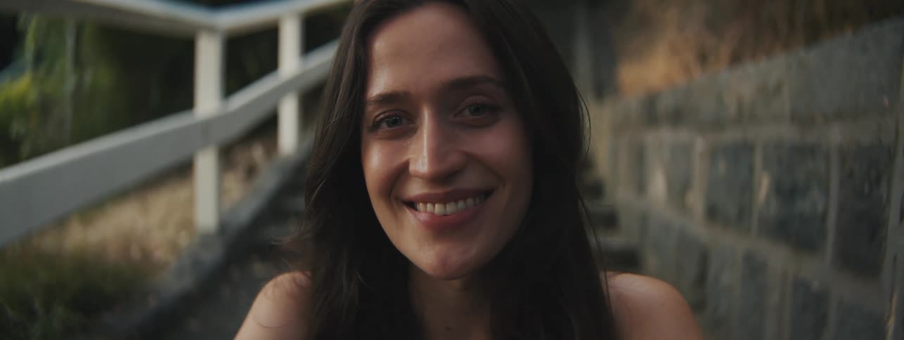 A woman is smiling outside