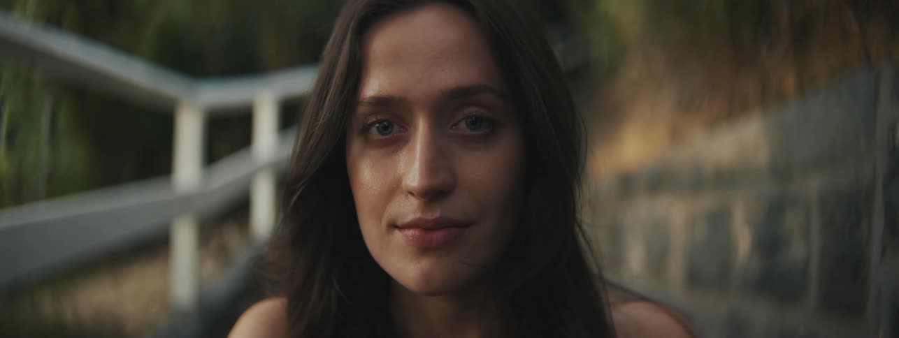 The face of a woman with green eyes who is staring straight ahead