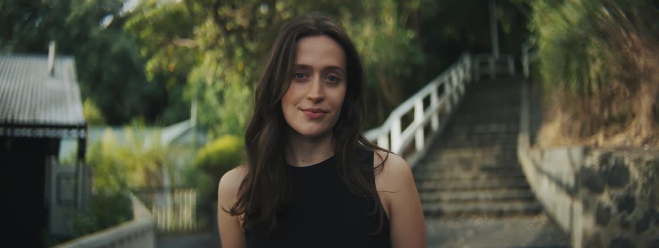 Portrait of a young woman with a smile while standing outdoors