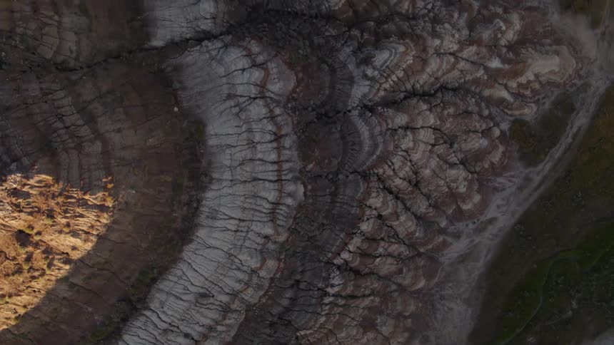 Top-down view of sedimentary rocks in the badlands at dusk