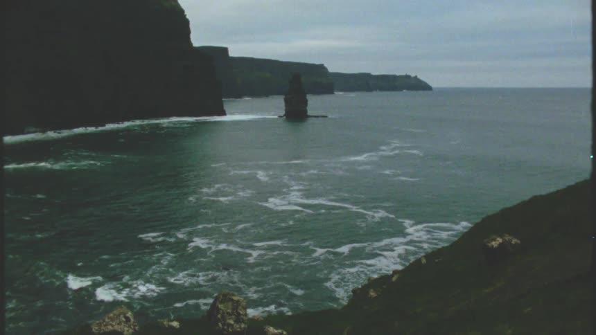 Waves lap the shore near the mountains