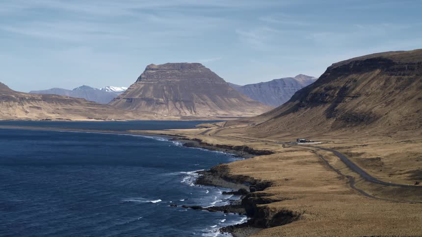 A building in a rural area sits right on the coast